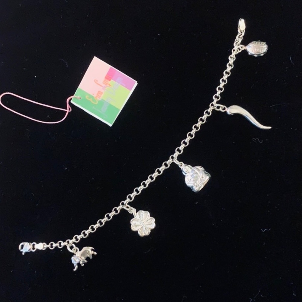 Sterling silver and peridot lucky charm bracelet.